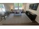 Sun-lit living room featuring modern furniture, large windows, and contemporary décor at 6814 Galloway Dr, Middlesex, NC 27557