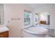 Relaxing bathroom featuring a garden tub with granite surround and large window view at 7850 Nc 42, Holly Springs, NC 27540