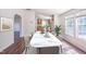 Bright dining room with a modern marble table, seating for six, hardwood floors, and easy kitchen access at 7850 Nc 42, Holly Springs, NC 27540