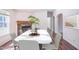 Elegant dining room featuring a modern marble table, seating for six, and a charming brick fireplace at 7850 Nc 42, Holly Springs, NC 27540