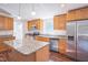 Charming kitchen featuring an island with granite countertops and stainless steel appliances at 7850 Nc 42, Holly Springs, NC 27540