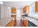 Charming kitchen featuring granite countertops, stainless steel appliances and wood cabinetry at 7850 Nc 42, Holly Springs, NC 27540