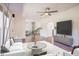 Open-concept living room with stylish furniture, hardwood floors, natural light, and a view to a second living space at 7850 Nc 42, Holly Springs, NC 27540