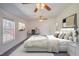 Inviting primary bedroom with a ceiling fan, plush bedding, a desk and one window for light at 7850 Nc 42, Holly Springs, NC 27540