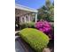 Lush landscaping surrounds a brick home and covered patio, with ample greenery at 811 S First St, Smithfield, NC 27577