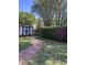 Charming backyard with a brick path, storage shed, and blooming bushes at 811 S First St, Smithfield, NC 27577