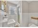 Bright bathroom with a shower, white tiled walls, and a window providing natural light at 811 S First St, Smithfield, NC 27577