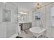Bright bathroom featuring a standalone tub, glass shower, and gray cabinets at 811 S First St, Smithfield, NC 27577