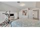 Bedroom with exercise equipment, neutral colors, patterned bedspread, and sloped ceiling at 811 S First St, Smithfield, NC 27577