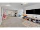 A bright and airy bonus room with neutral paint, plush carpeting, and a large tv at 811 S First St, Smithfield, NC 27577