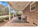 Cozy covered patio features brick pavers, a rocking chair, and decorative string lights at 811 S First St, Smithfield, NC 27577