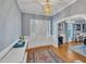 Bright foyer showcasing a white front door, hardwood floors, stylish lighting, and smooth flow into other living areas at 811 S First St, Smithfield, NC 27577