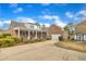 A large brick home with a long driveway, mature landscaping, and a shed at 811 S First St, Smithfield, NC 27577