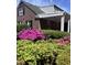 Beautiful brick home with lush landscaping and a covered patio with string lights at 811 S First St, Smithfield, NC 27577