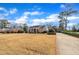 Expansive front yard with a brick home featuring a cozy porch, classic architectural design, and inviting curb appeal at 811 S First St, Smithfield, NC 27577