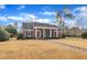 Inviting brick home showcasing a covered porch, classic landscaping, and a welcoming entrance with a brick walkway at 811 S First St, Smithfield, NC 27577