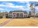 Charming brick home featuring a columned front porch, red door, and well-maintained landscaping at 811 S First St, Smithfield, NC 27577