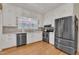Bright kitchen boasts stainless appliances, generous countertop space, and white cabinetry at 811 S First St, Smithfield, NC 27577