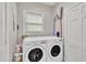 Convenient laundry room featuring modern, white front-loading washer and dryer at 811 S First St, Smithfield, NC 27577