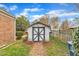 An outdoor shed with a white and gray exterior and a brick pathway at 811 S First St, Smithfield, NC 27577