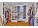 Spacious walk-in closet with custom shelves, ample storage, hardwood floors, and a bench near the window at 811 S First St, Smithfield, NC 27577