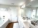 Bathroom featuring double sinks, vanity, and a tub in neutral decor at 897 W Main St, Benson, NC 27504
