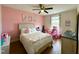 Charming bedroom with a decorative ceiling fan, pink walls, and a comfortable bed at 897 W Main St, Benson, NC 27504