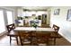 The dining area features wood flooring, table with six chairs, and views into the modern kitchen at 897 W Main St, Benson, NC 27504
