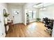 Inviting home entry with hardwood floors, a decorative table, and a view into the adjacent office space at 897 W Main St, Benson, NC 27504