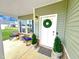Inviting front porch with rocking chairs, plants and a welcoming wreath on the front door at 897 W Main St, Benson, NC 27504