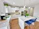 Bright kitchen features a center island, white cabinets, stainless steel appliances, and modern decor at 897 W Main St, Benson, NC 27504