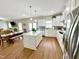 Open-concept kitchen with a large island, stainless steel appliances, and dining area at 897 W Main St, Benson, NC 27504