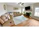 Cozy living room with hardwood floors, a fireplace, large windows, and comfortable seating at 897 W Main St, Benson, NC 27504