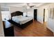 This main bedroom has hardwood floors, a tray ceiling with fan, and a walk-in closet at 897 W Main St, Benson, NC 27504