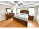 The main bedroom has an updated ceiling fan and hardwood floors and a dark wood bedroom set at 897 W Main St, Benson, NC 27504
