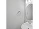 Stylish half bathroom featuring a pedestal sink and round mirror at 92 Ripple Way # 315, Clayton, NC 27520