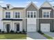 Charming townhome exteriors with two-car garages, neat lawns and beautiful landscaping at 92 Ripple Way # 315, Clayton, NC 27520