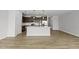 Contemporary kitchen featuring an island, stainless steel appliances, and wood-look flooring at 92 Ripple Way # 315, Clayton, NC 27520