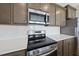 Close-up showcasing stainless steel appliances, white subway tile backsplash and granite countertops in a modern kitchen at 92 Ripple Way # 315, Clayton, NC 27520