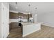 Modern kitchen featuring an island, stainless steel appliances, granite countertops, and sleek brown cabinetry at 92 Ripple Way # 315, Clayton, NC 27520