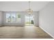Bright living room with a modern light fixture and sliding glass doors that lead to the backyard at 92 Ripple Way # 315, Clayton, NC 27520