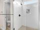 Modern tiled shower with glass door, a rainfall shower head, and a built-in bench at 9246 Otter Ct, Middlesex, NC 27557