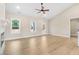 Spacious living room featuring large windows that flood the space with natural light and fan at 9246 Otter Ct, Middlesex, NC 27557