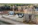 The home is surrounded by bare trees and well-maintained landscaping in an aerial view at 955 Lynch Rd, Selma, NC 27576