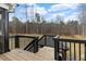 Spacious back porch with stairs and black metal railings, perfect for outdoor living and entertaining at 955 Lynch Rd, Selma, NC 27576
