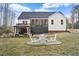 Enjoy the outdoor space with a covered deck, beautiful gazebo, and firepit with chairs at 955 Lynch Rd, Selma, NC 27576