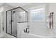 Elegant bathroom featuring a soaking tub, glass-enclosed shower, and tiled walls create a spa-like experience at 955 Lynch Rd, Selma, NC 27576