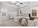 Bright bedroom with tray ceiling, carpet flooring, with windows offering natural light and a comfortable atmosphere at 955 Lynch Rd, Selma, NC 27576