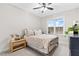 Bright bedroom with a large window, natural light and neutral decor with decoratively pillowed bed at 955 Lynch Rd, Selma, NC 27576