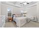 Spacious main bedroom with tray ceiling, large windows, and neutral decor creating a serene and inviting retreat at 955 Lynch Rd, Selma, NC 27576